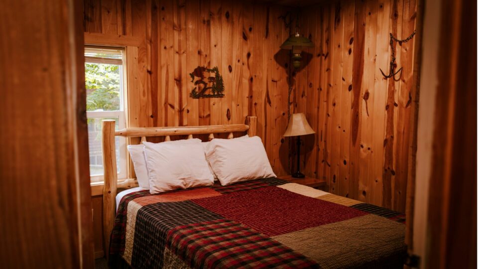 Queen bed in a cabin rental at a Minnesota resort.